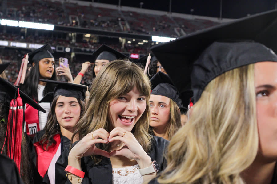 A student celebrating on graduation day.