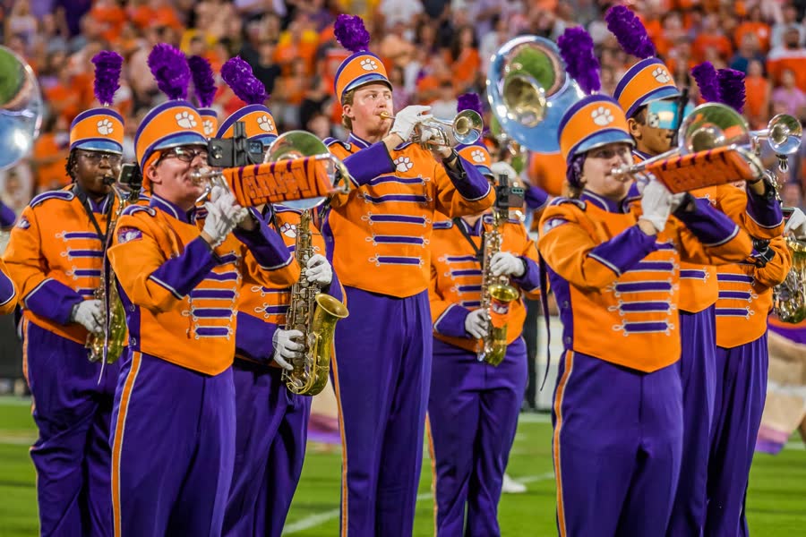 A student marching with the college band.